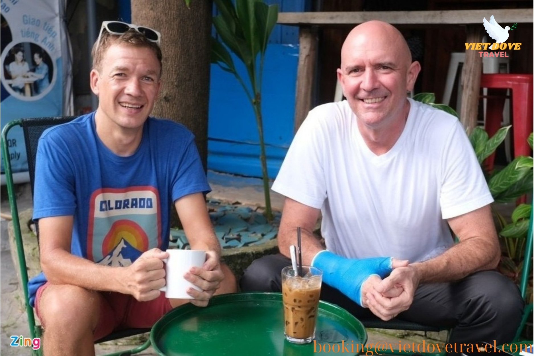 Two foreign travelers sharing coffee and smiles in Hoi An